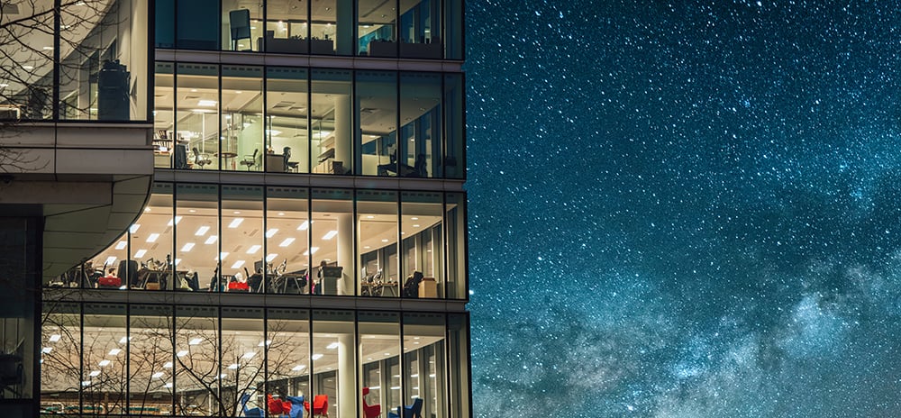 An external shot of an office, the stars shining in the background