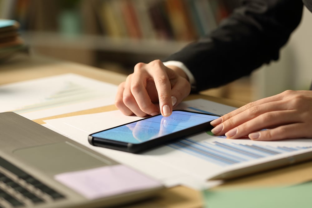 A close-up shot of two hands working on a smartphone